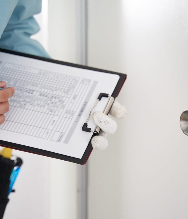 a-japanese-male-worker-checks-the-locks-on-a-house-2026-03-24-09-07-48-utc
