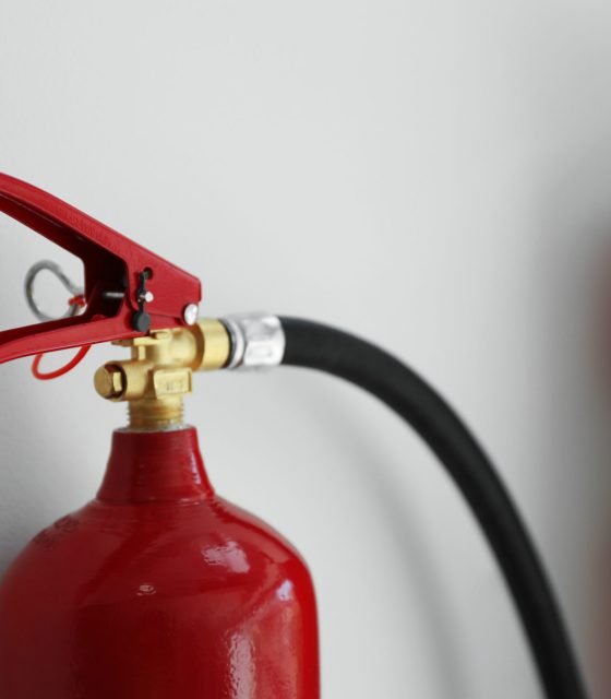 Fire extinguisher on white background, closeup view